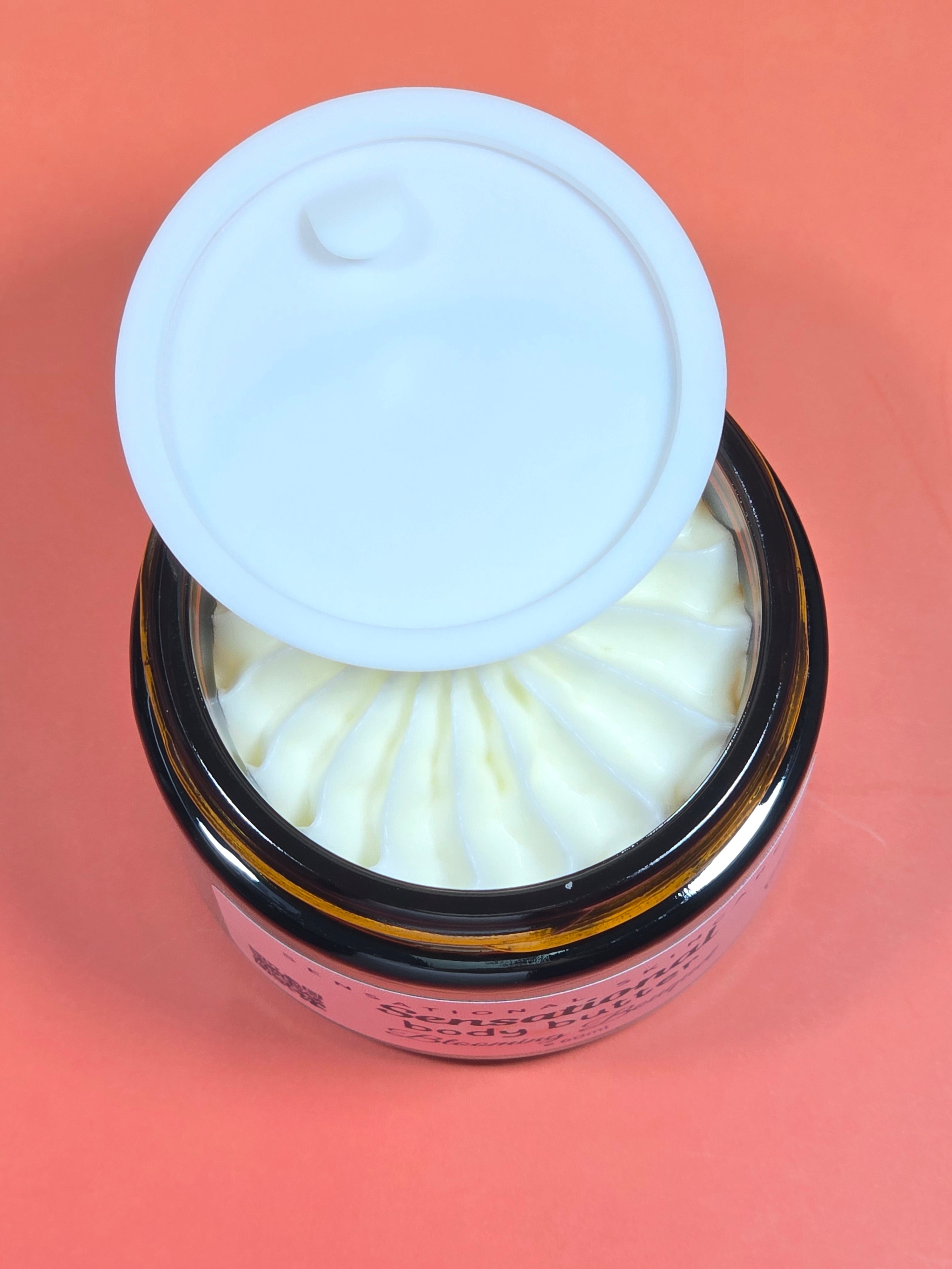 Jar of Sensational skin care body butter on a pink background